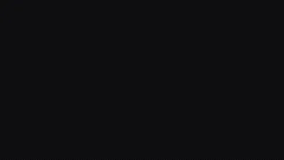 An almost flat black field with the faintest lift toward the upper left, close enough to #000000 to save power on an OLED panel.