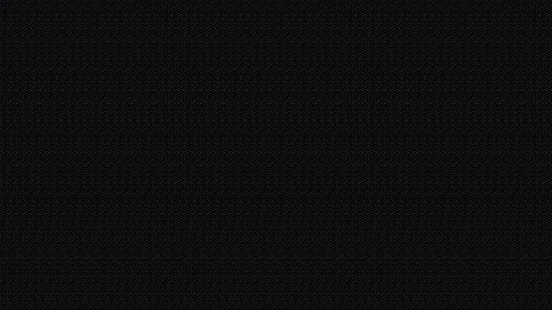 An almost flat black field with the faintest lift toward the upper left, close enough to #000000 to save power on an OLED panel.