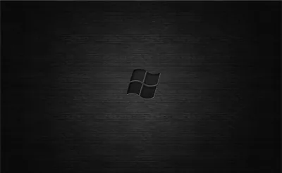 The old waving flag emblem is stamped in black on a horizontally brushed dark panel, lit slightly brighter around the middle.