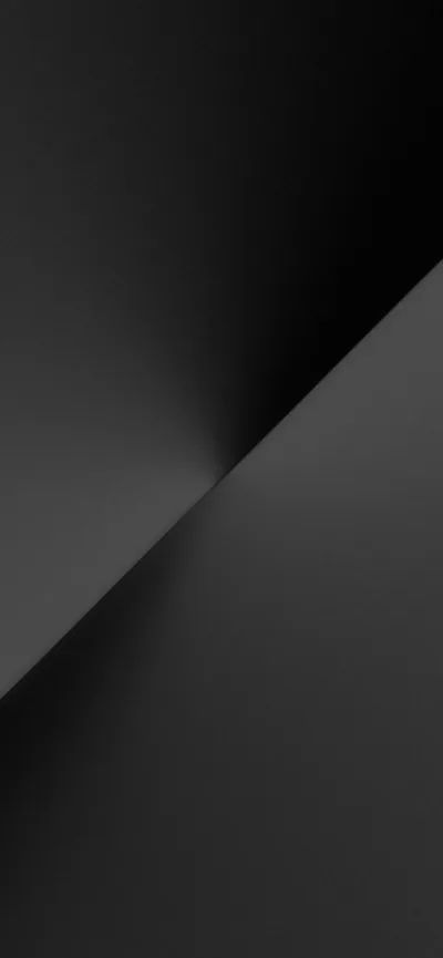 One clean diagonal divides the frame, light grey above and near-black below, with a soft glow where the two meet.
