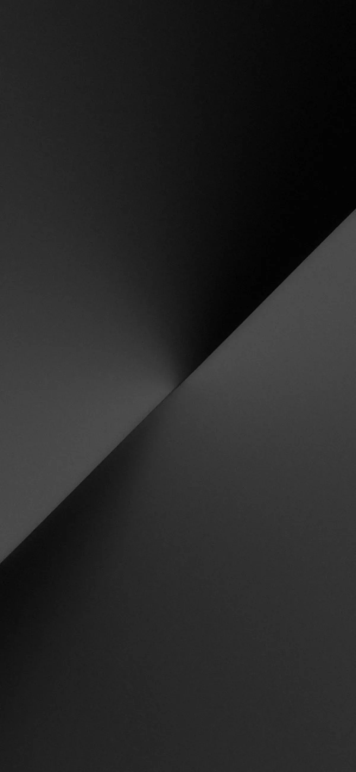 One clean diagonal divides the frame, light grey above and near-black below, with a soft glow where the two meet.