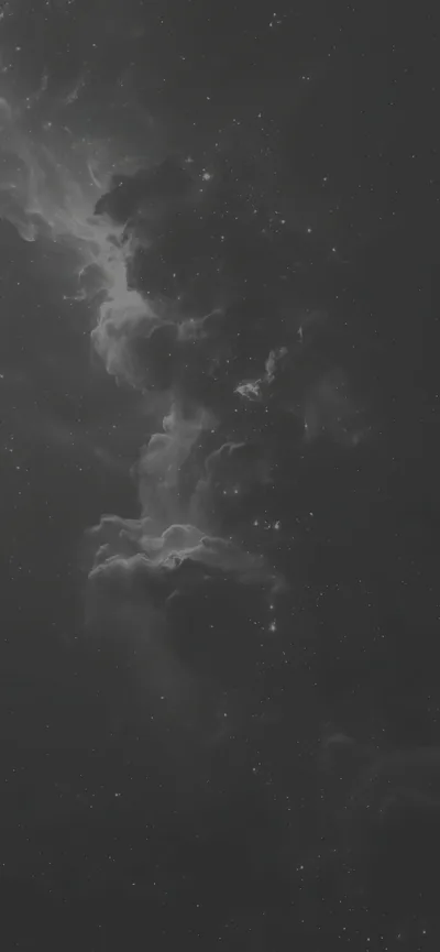 Soft grey nebula clouds drift down a tall narrow frame in low contrast, only a scatter of small stars breaking the grain.