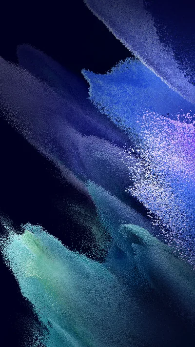Powder-like bursts of blue, violet and teal rise from the lower left against near-black navy, with the brightest speckled highlights clustered along the right side.