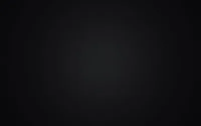 A dim grey light spreads out from the middle of a black panel and falls away evenly toward all four corners.