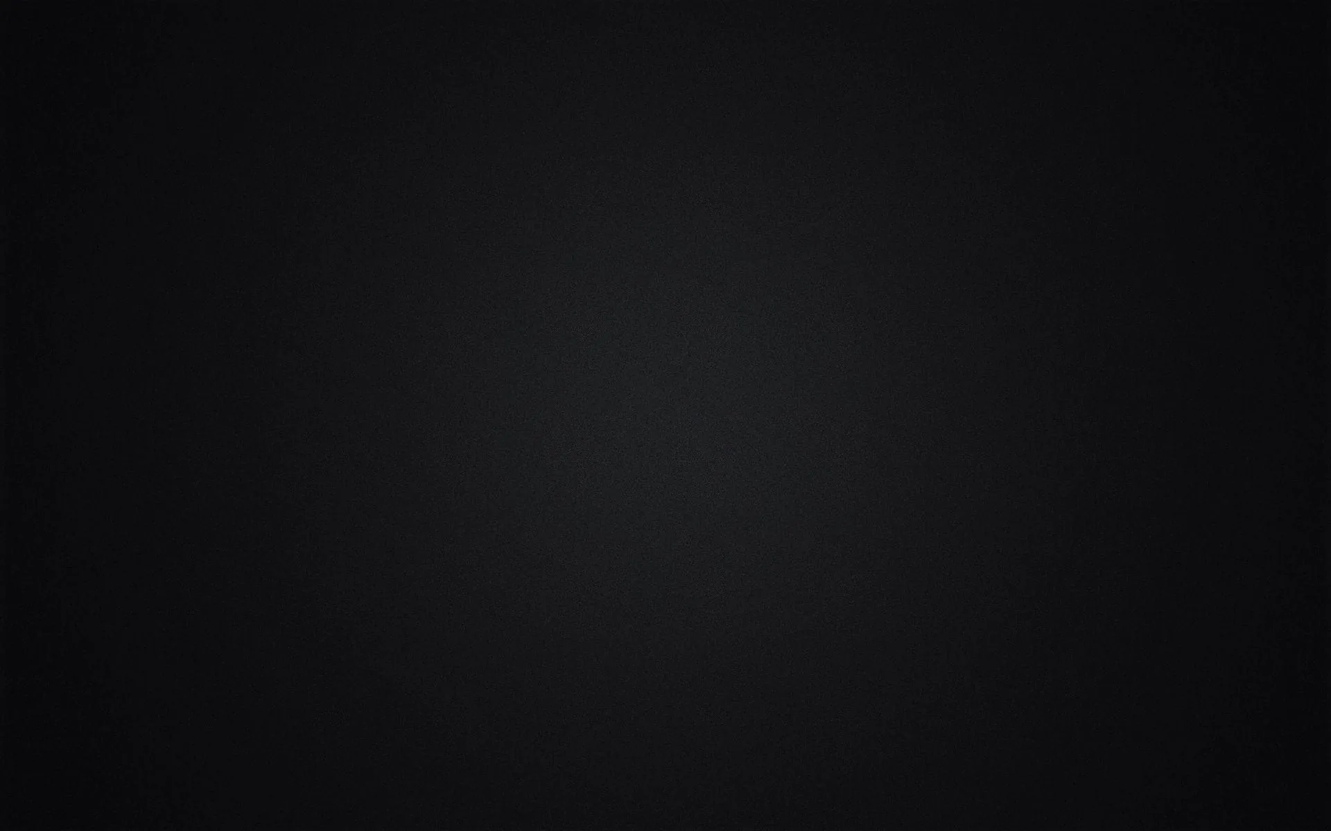 A dim grey light spreads out from the middle of a black panel and falls away evenly toward all four corners.