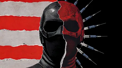 A mask torn in two down the centre — black goggles on one side, a painted red skull on the other — with faded flag stripes behind.