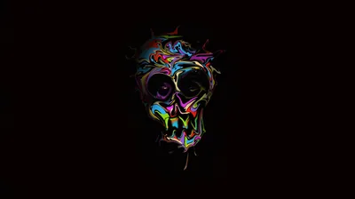 A skull drawn in loose neon strokes floats centred on black, the colour scattering outward like paint flicked at it.