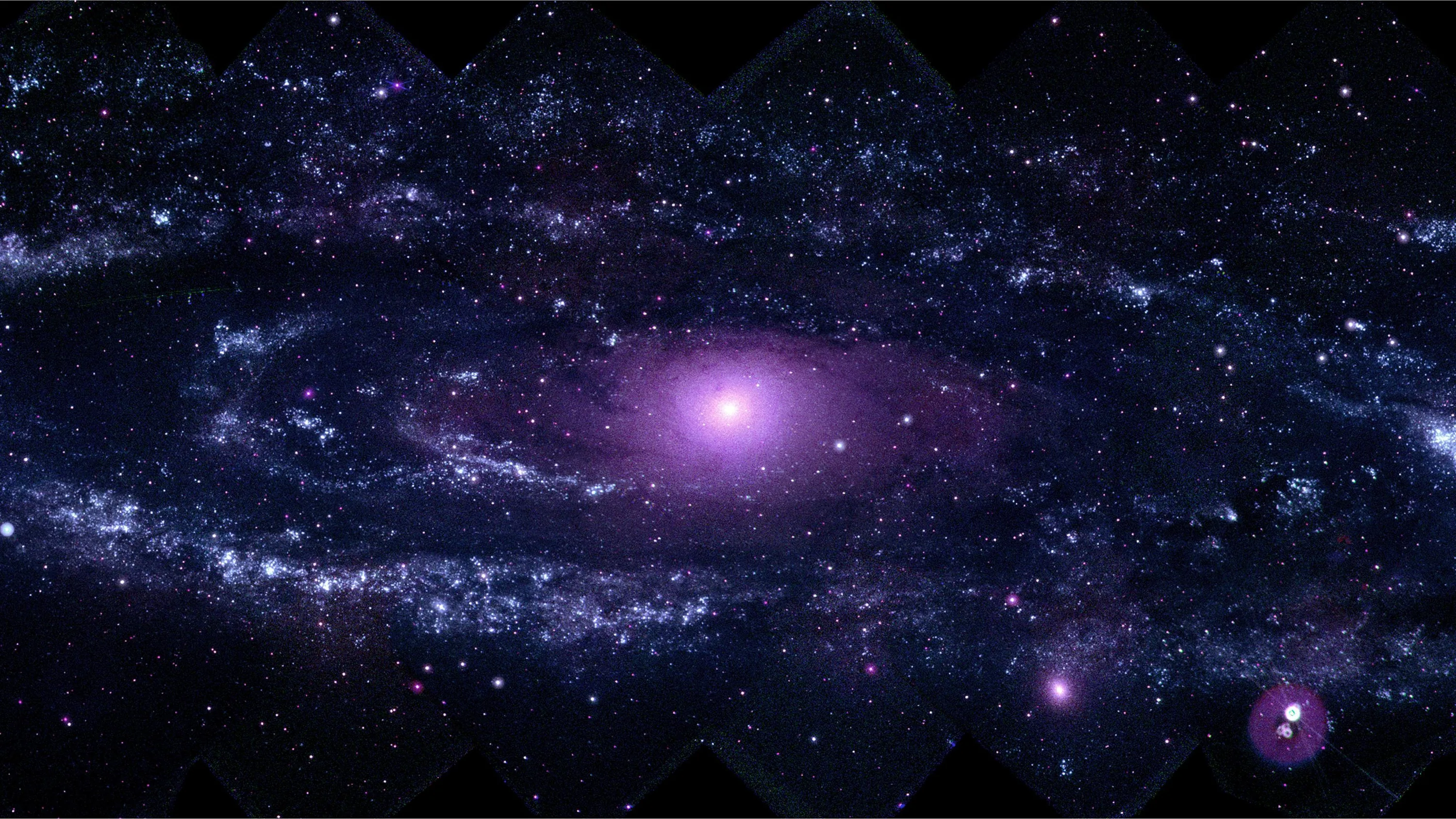 A wide violet galaxy spreads its arms from a pale glowing core, with a smaller bright object flaring at the lower right corner.