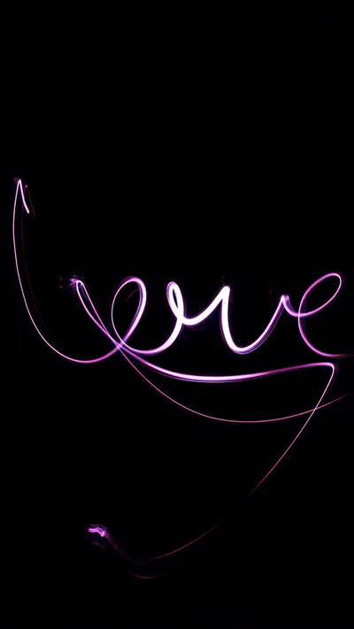 A single violet light trail loops through the word love and tails off toward the bottom of an otherwise black portrait frame.