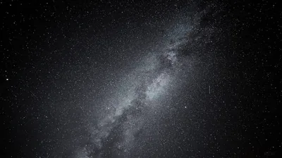 The galactic band runs corner to corner in greyscale, its dark dust lane clearly split down the middle of the glow.