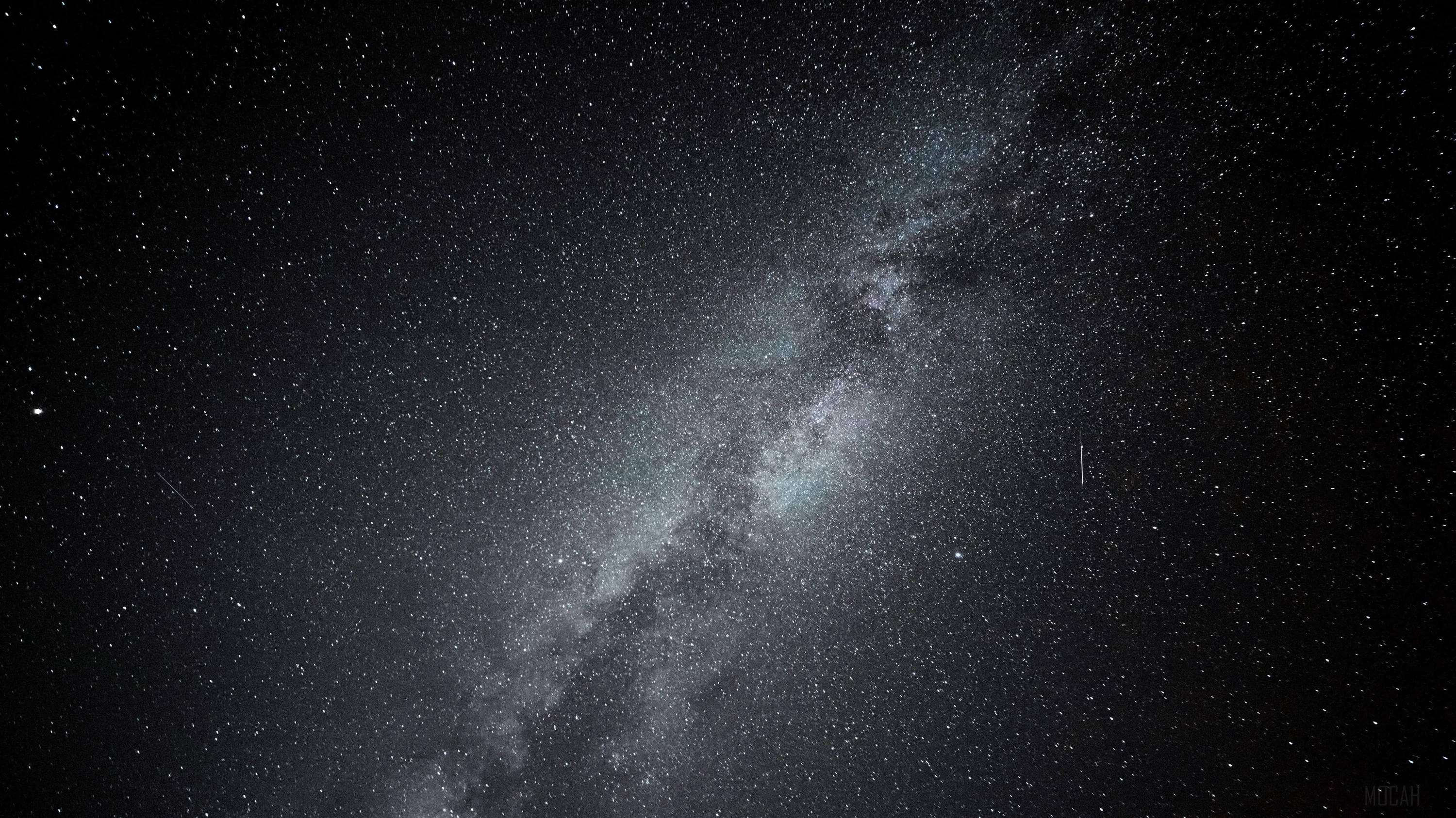 The galactic band runs corner to corner in greyscale, its dark dust lane clearly split down the middle of the glow.