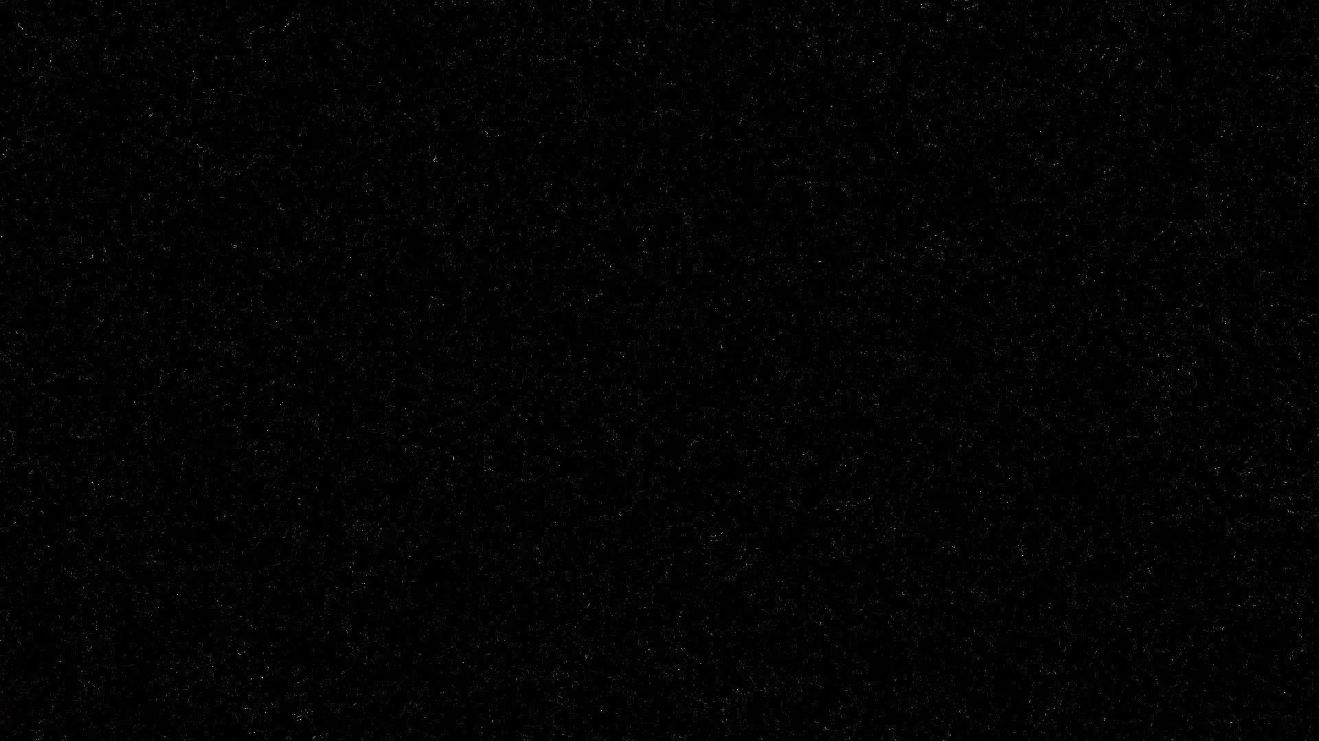 Fine pale specks scatter unevenly across solid black like distant stars or film grain, thinning out toward the bottom of the frame.