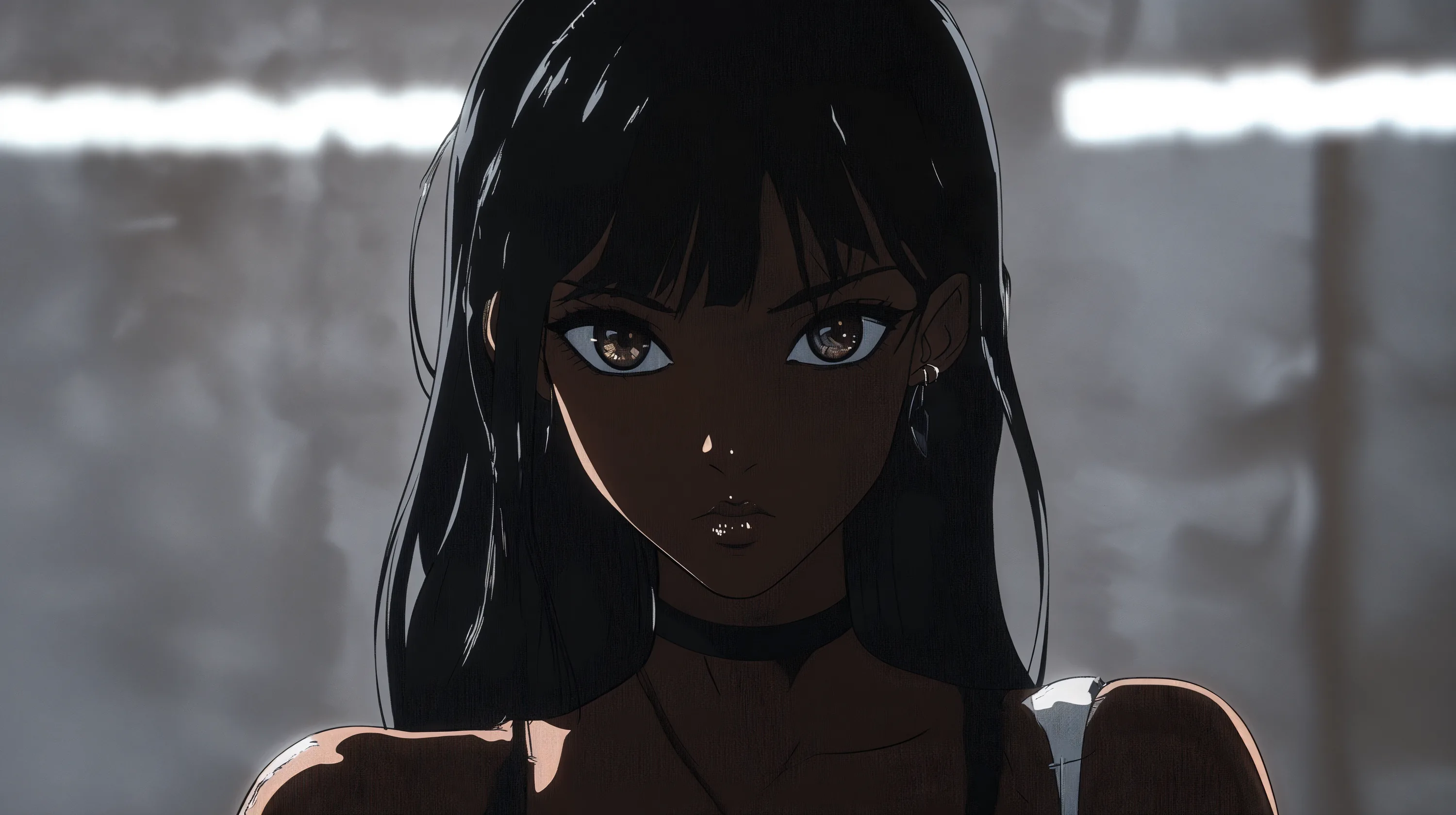 She leans forward in a black top and choker, soft grey light raking across the bare wall behind her and picking out a small lip piercing.