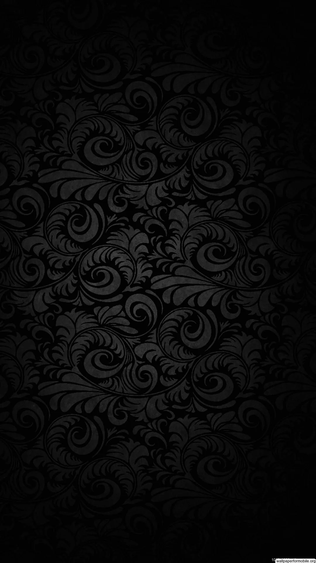 Ornate scrollwork repeats edge to edge in a barely lighter black, readable only where a dim glow catches the raised curls at the centre.