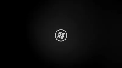 A round window badge sits centred on a black field with a soft grey glow spreading out behind it.