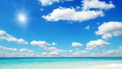 The sun flares in the top left above turquoise shallows and white sand, the clouds spaced widely enough to leave room for icons.