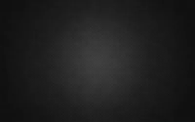 A near-black charcoal field with a faint fabric grain and a soft vignette, dim enough for desktop icons to stay readable anywhere on screen.