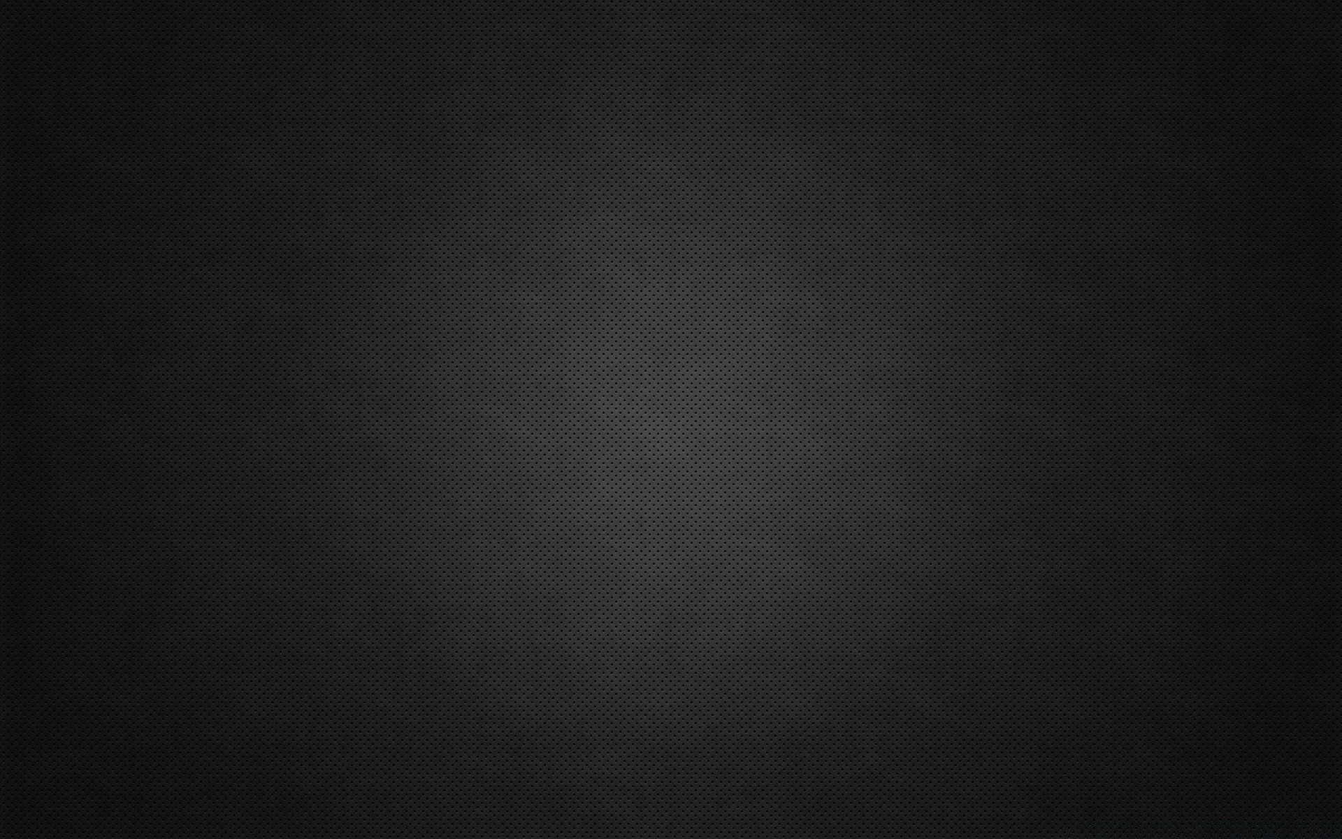 A near-black charcoal field with a faint fabric grain and a soft vignette, dim enough for desktop icons to stay readable anywhere on screen.
