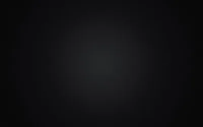 An almost featureless black gradient, only a faint glow lifting the centre — effectively flat black at the corners for OLED screens.