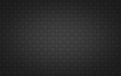 A small floral motif tiles edge to edge across dark grey, brightest through the middle band and vignetted down at all four corners.