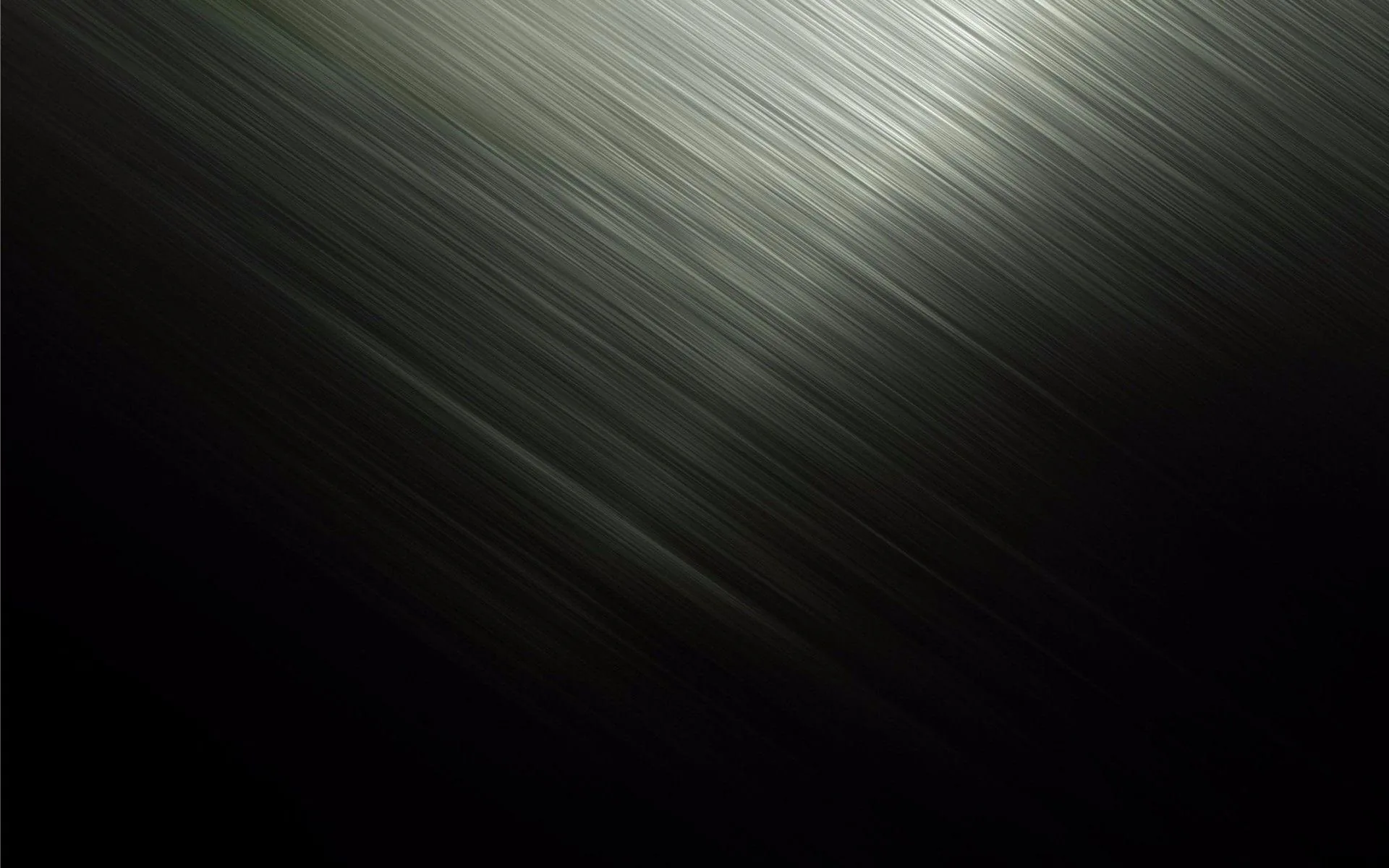 A band of brushed metal catches light diagonally through the frame, the rest falling into flat dark grey.