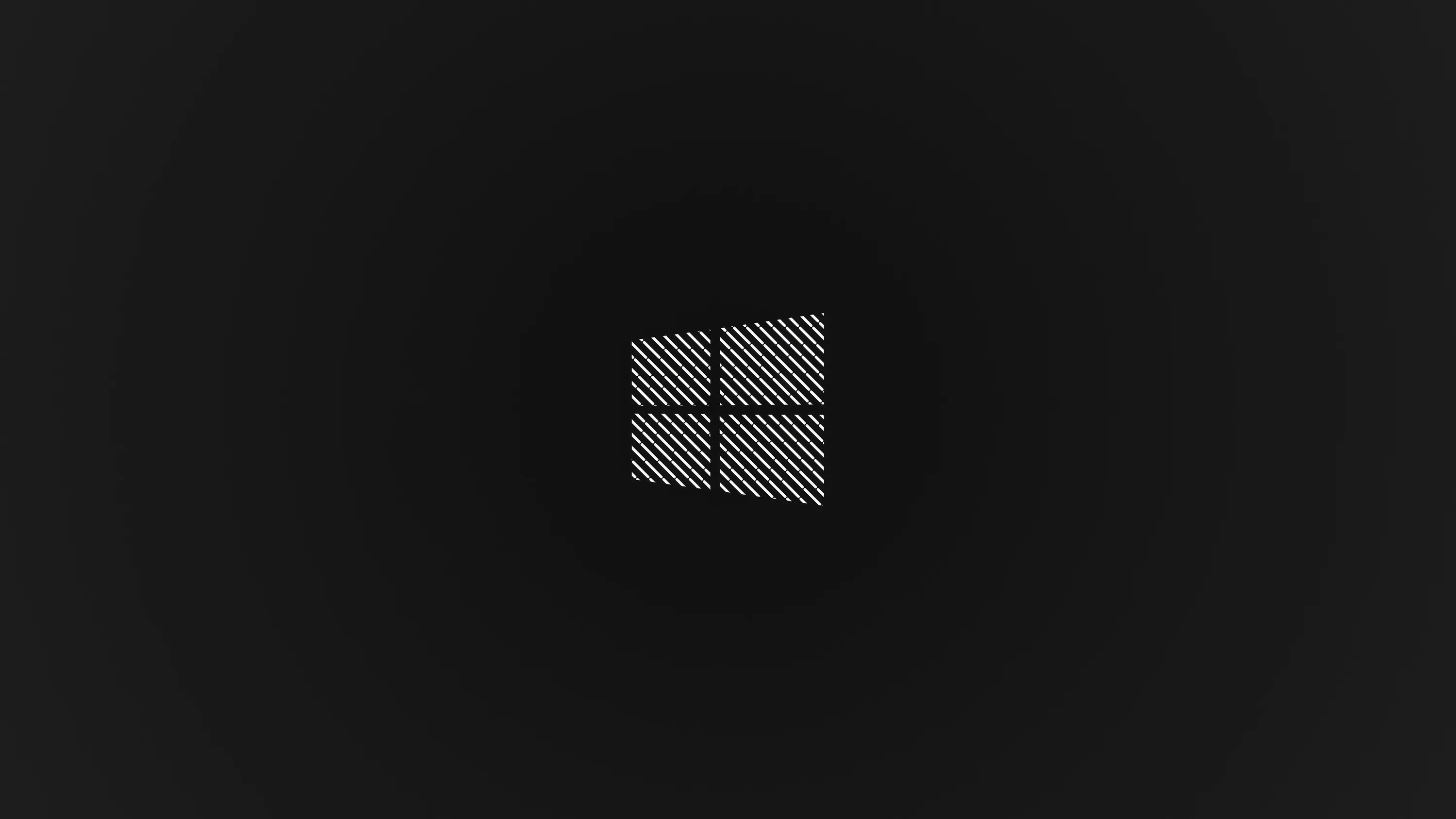 The four panes are filled with a fine woven mesh and sit slightly above centre on charcoal, the corners dropping away to near black.