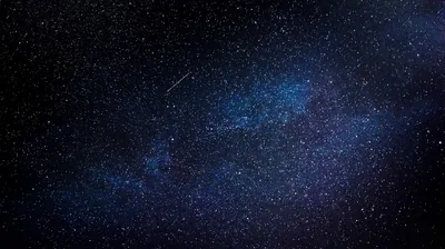 Mostly black frame with a faint blue stellar mist through the middle and a thin meteor scratch near the top — dim enough for OLED phones.