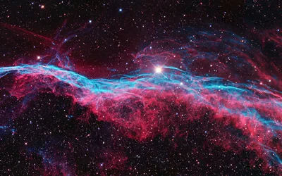 Thin ribbons of red and cyan gas curl through a star field, one bright star flaring near the top centre of the frame.