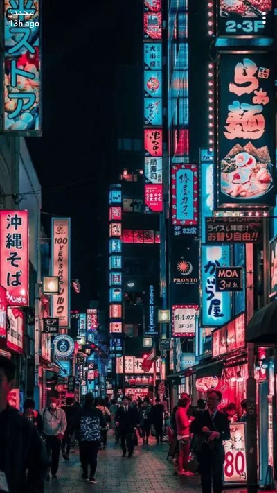 Stacked pink and cyan signboards, one advertising Okinawa soba, line both sides of a crowded night street, only a thin black strip of sky at top left.