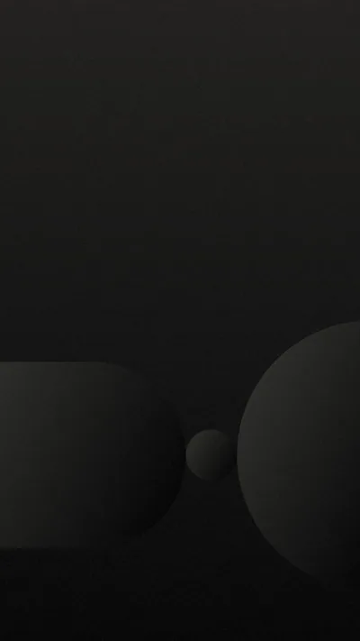 Two large rounded forms meet near the bottom of a charcoal gradient with a small ball resting in the gap between them.
