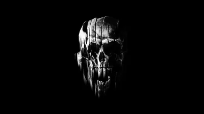 A skull turns three quarters toward the camera in hard monochrome, the brow and cheekbone burning white while the jaw dissolves into black.