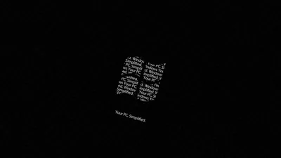 Four panes of tiny white type form the Windows mark at the centre of a black screen, with a small caption underneath.