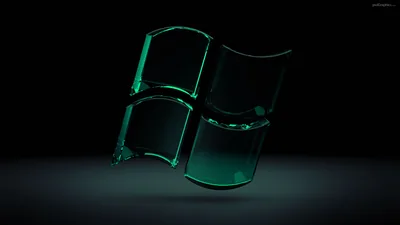 The four-pane Windows mark rendered as thick translucent green glass, floating above its own reflection on a dark floor.