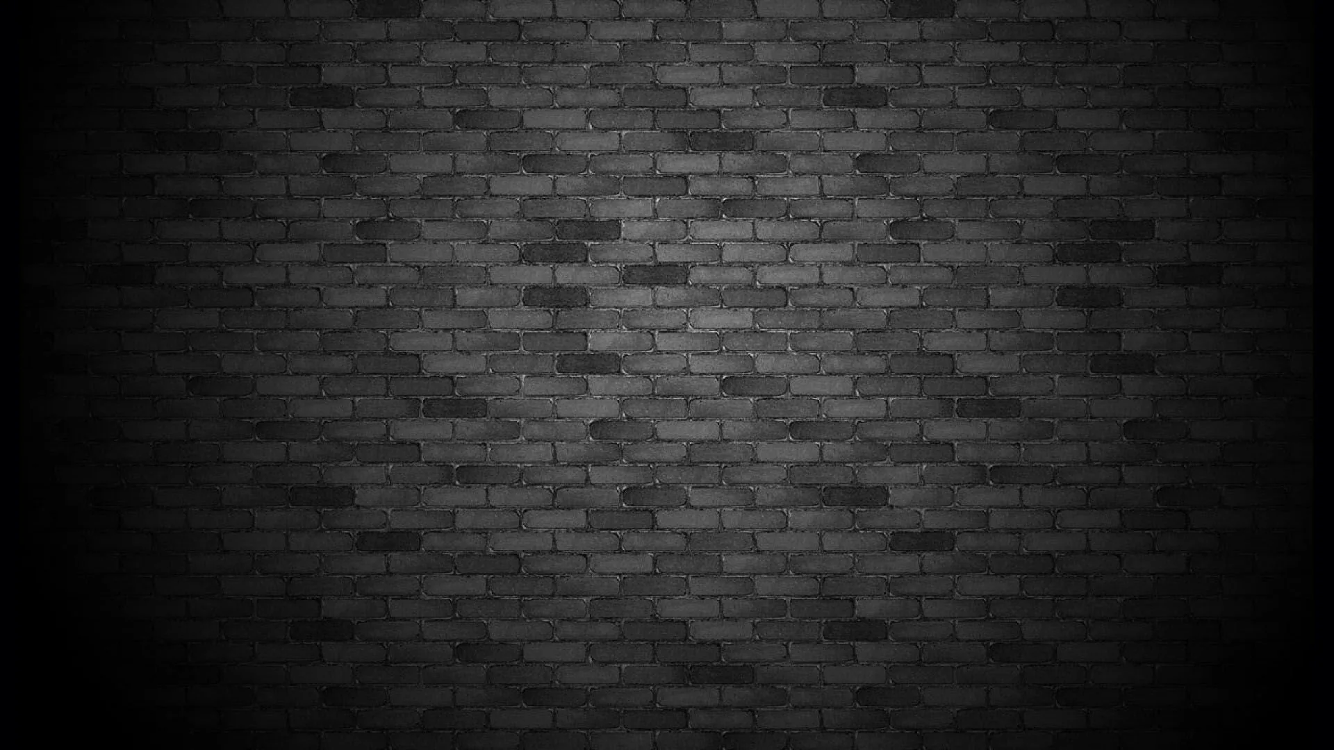 A soft pool of light lands in the middle of a grey brick wall and falls away to black at both sides, leaving the corners empty for icons.