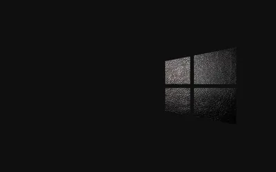 A grainy window mark sits on the right of a black field with its reflection stretching down below it.