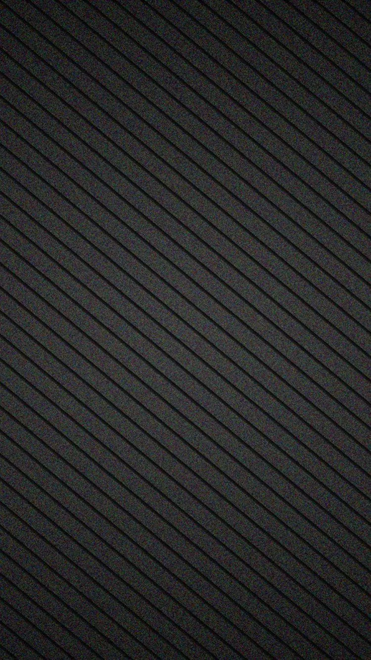 Fine diagonal ridges run corner to corner in charcoal grey, an even repeating weave with no bright spot anywhere in the frame.