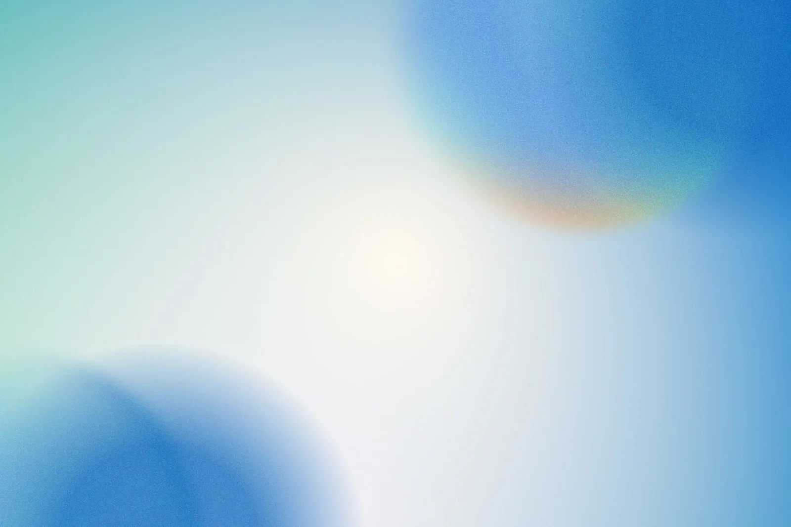 Two out-of-focus blue discs sit in opposite corners of a pale sky-white field, with a faint warm glint on the upper one.