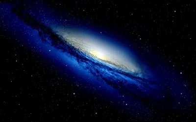 Deep blue arms curl around a white-hot core, the galaxy set low-right in the frame with a plain starry sky filling the rest.