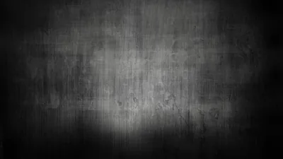 Scuffed grey plaster fades to black at every edge — enough texture to avoid looking flat, nothing more.
