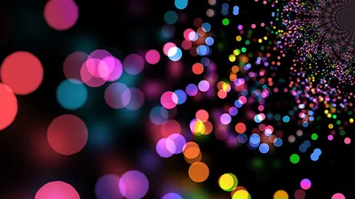 Round bokeh discs in pink, blue and green crowd the left side while a spiral of tiny dots curls into the top-right corner.