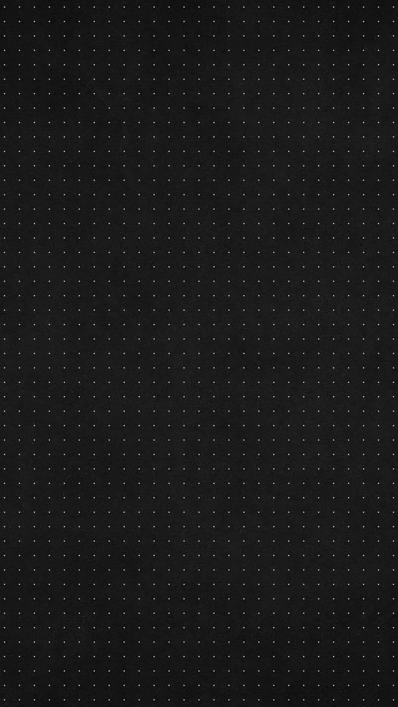 A dense grid of pinpoint dots covers a charcoal surface edge to edge, even enough that nothing pulls the eye to one spot.