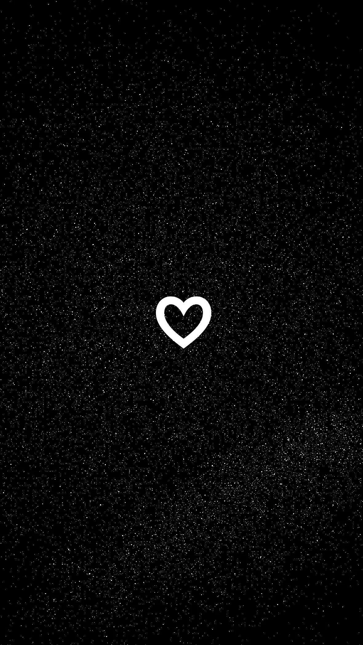 A thin white heart outline sits just above centre on a grainy black field, the rest of the frame left empty and dark.