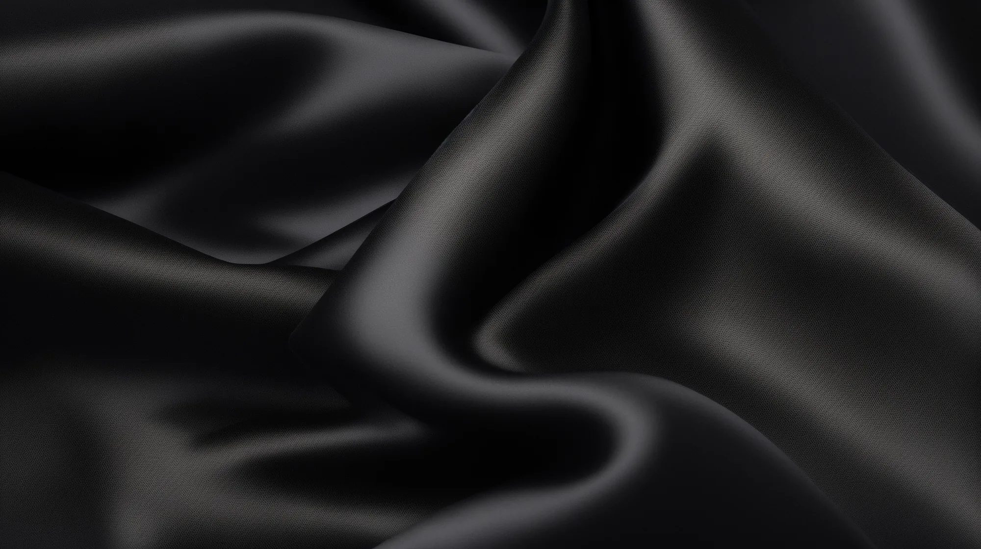 Heavy black satin gathers into soft folds, the light running along each ridge and dying in the troughs between them.