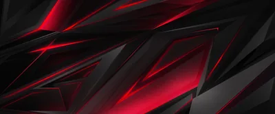 Sharp diagonal planes of matte black overlap in an ultrawide frame, red light catching along every cut edge.