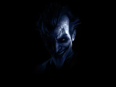 Cold blue light picks out a gaunt grinning face and swept-back hair from total darkness, light falling from the upper left across the cheekbones.
