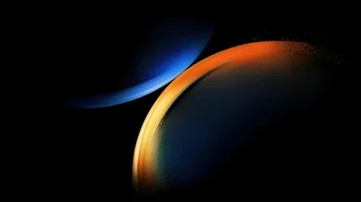 An orange-rimmed ring overlaps a dim blue arc on solid black, both circles held right of centre so the left side stays unlit for docks and icons.