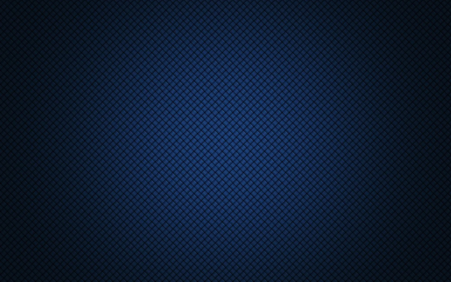 A fine diamond weave covers a deep navy surface, a soft radial lift through the centre and the borders falling to near-black.