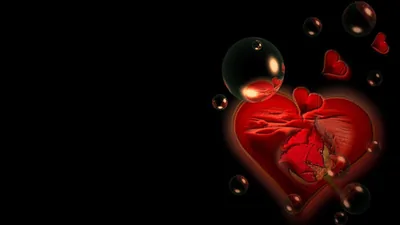 A glossy red heart glows on the right side of the frame among floating bubbles, the left half kept in flat black.