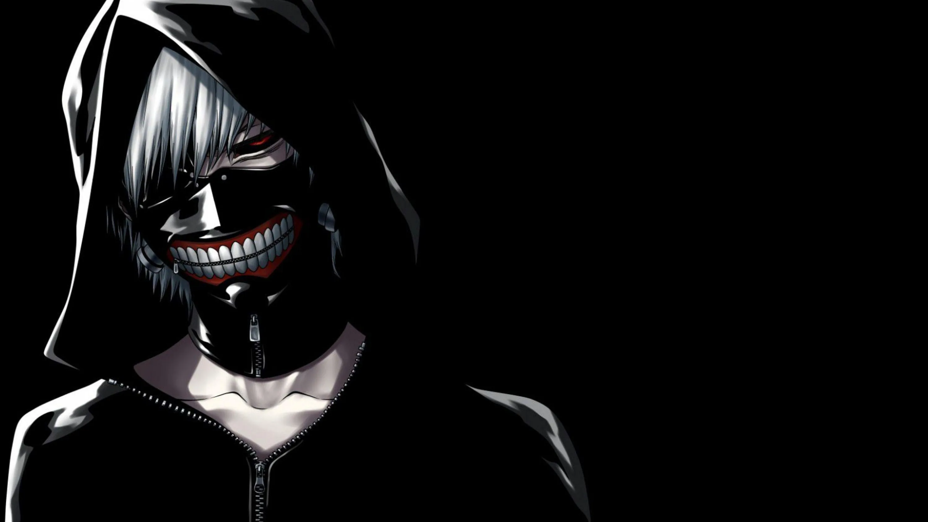 A leather mask with a metal grin and a raised hood, side-lit so the right half of the body disappears entirely into black.