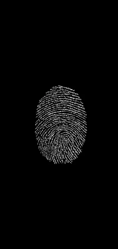 A single fingerprint sits centred in fine white ridges, the whorl clearly readable while the rest of the frame stays flat black.